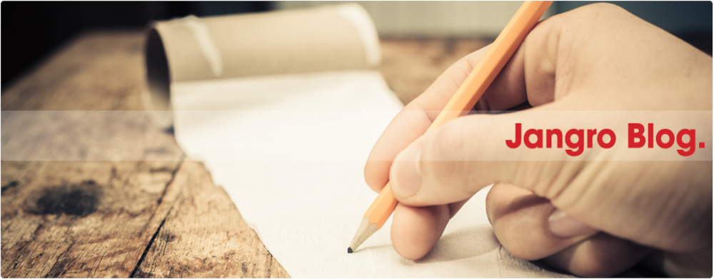 picture of a hand holding a pencil and writing on roll of tissue paper on a table